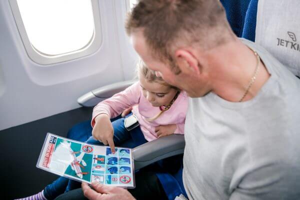girl and dad looking at safety card